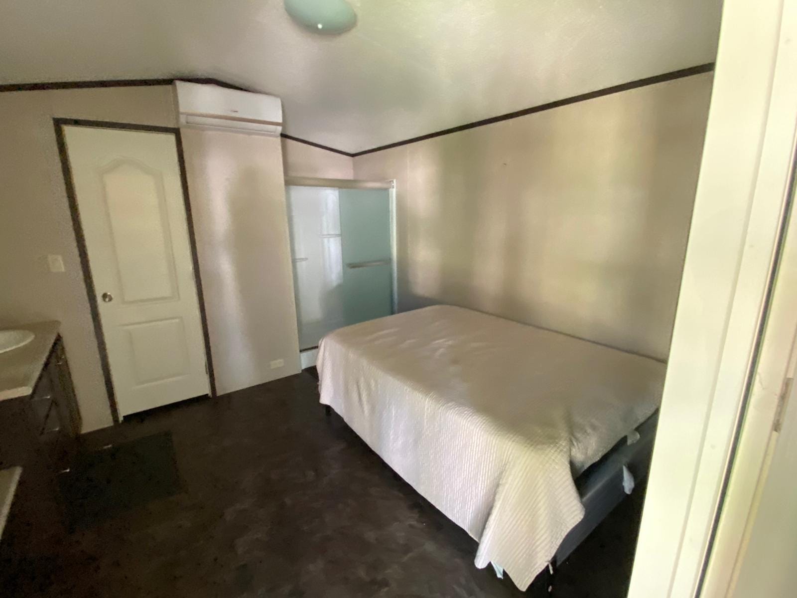 Studio bedroom with queen bed and shower