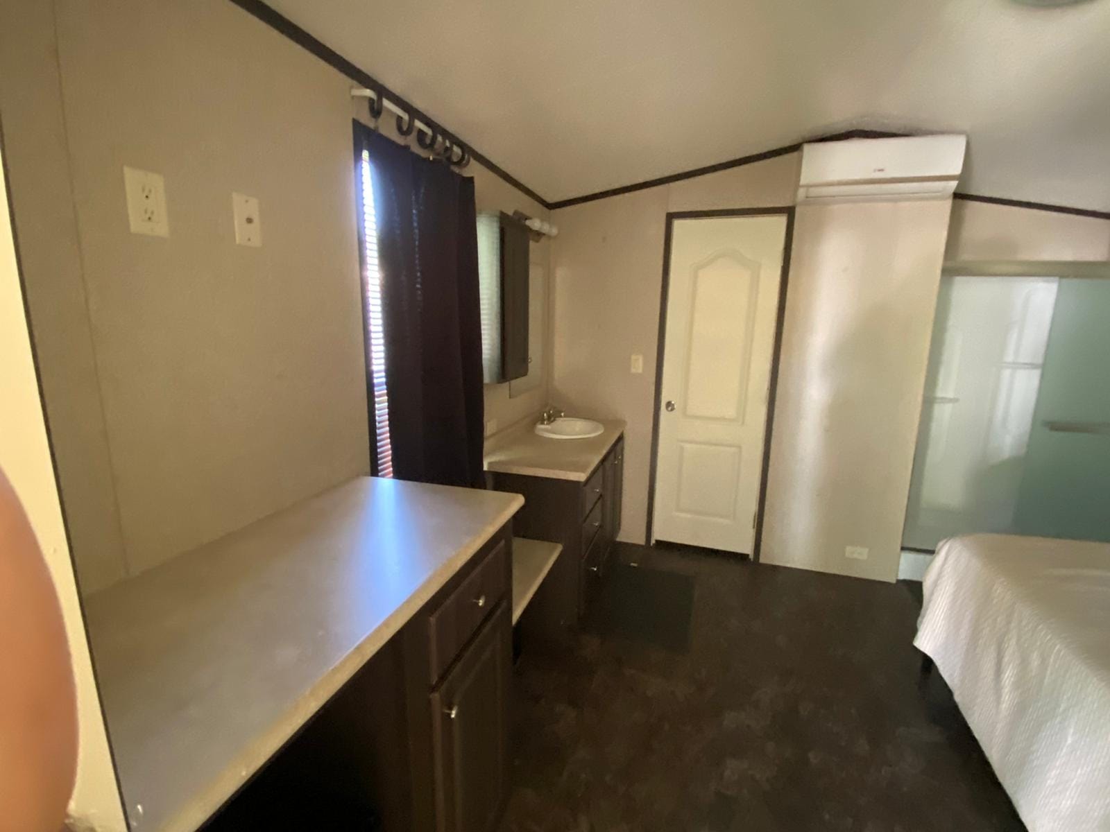 Studio bedroom with vanity, sink, and AC unit